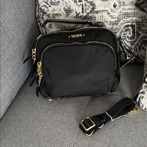 TUMI Black Crossbody Bag with Gold Accents